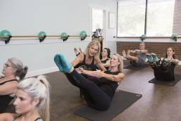 pilates and yoga instructor during class